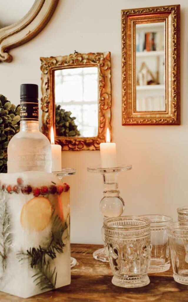 Lovely DIY Ice Bucket displayed beautifully with candles, and vintage glassware for the holidays.