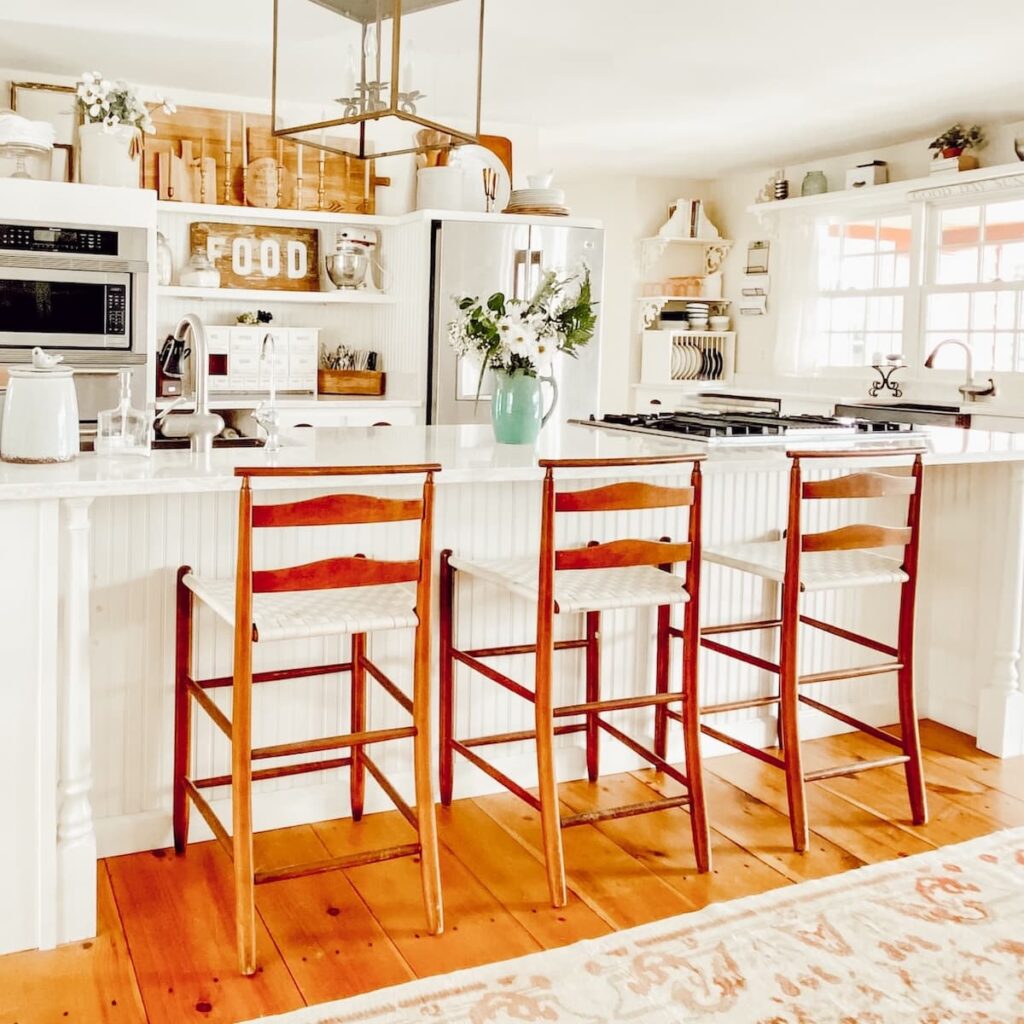 White farmhouse kitchen with Sherwin Williams Navajo White Wall paint.