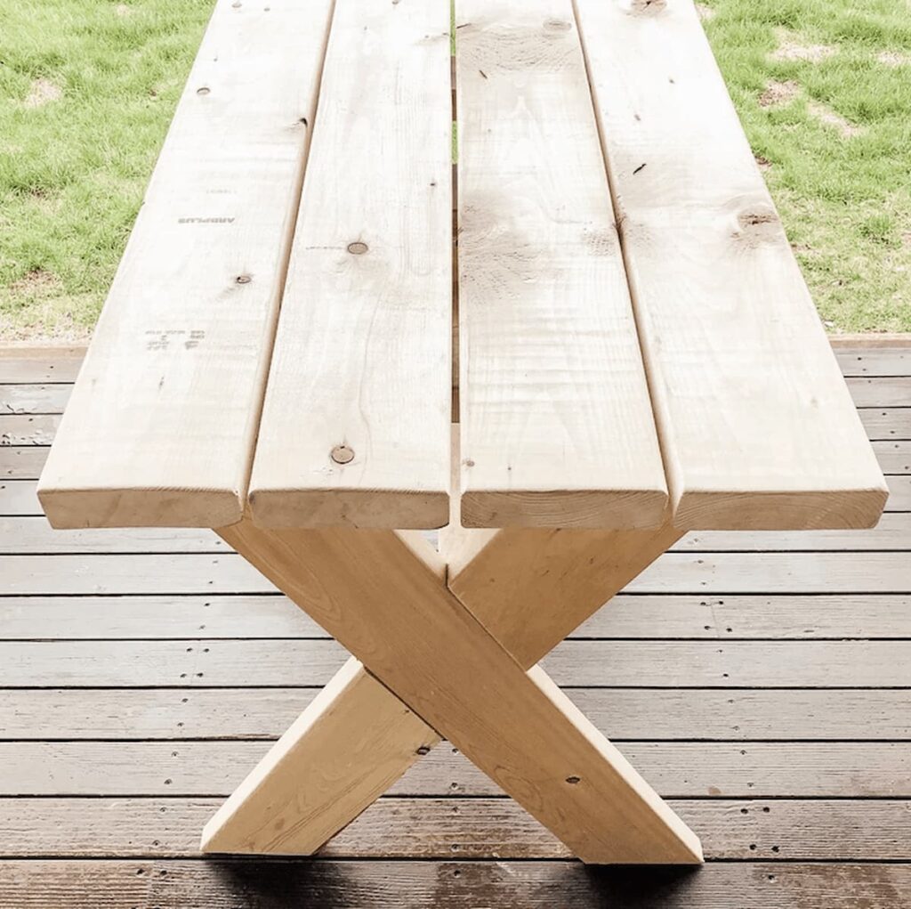 DIY garden table unfinished on porch.