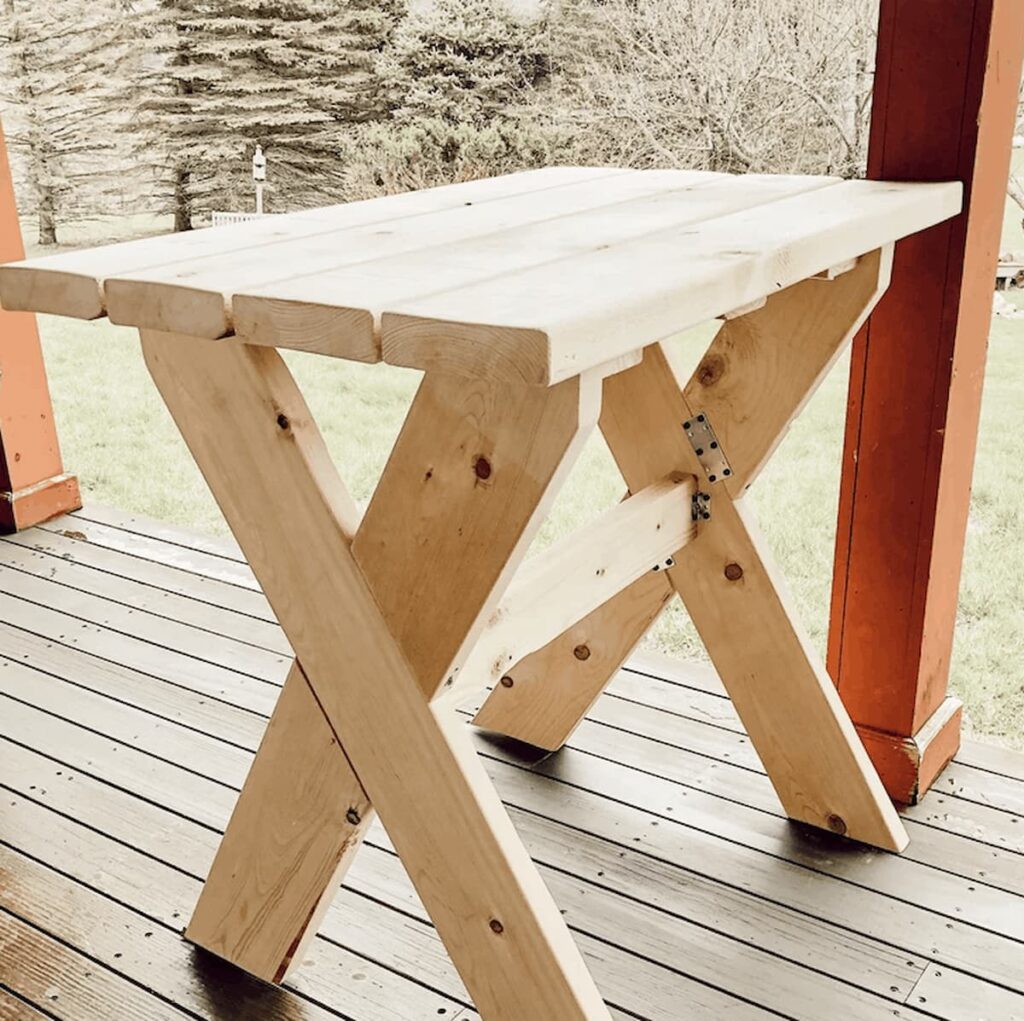 DIY garden table unfinished on porch.