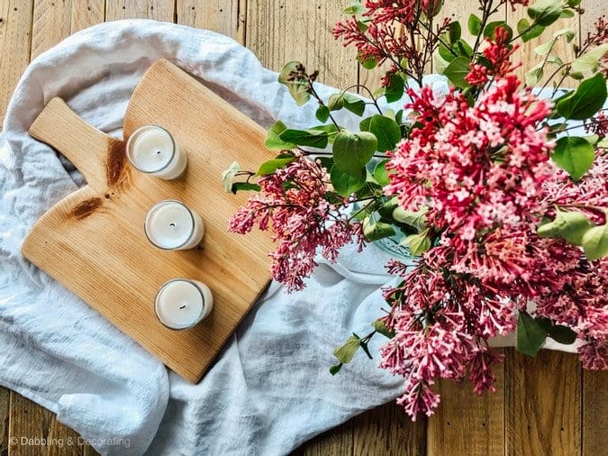 DIY Breadboard with candles and pink flowers at picnic set up.