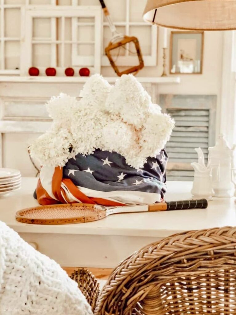 Patriotic Centerpiece with American Flag White Hydrangeas and vintage tennis rackets