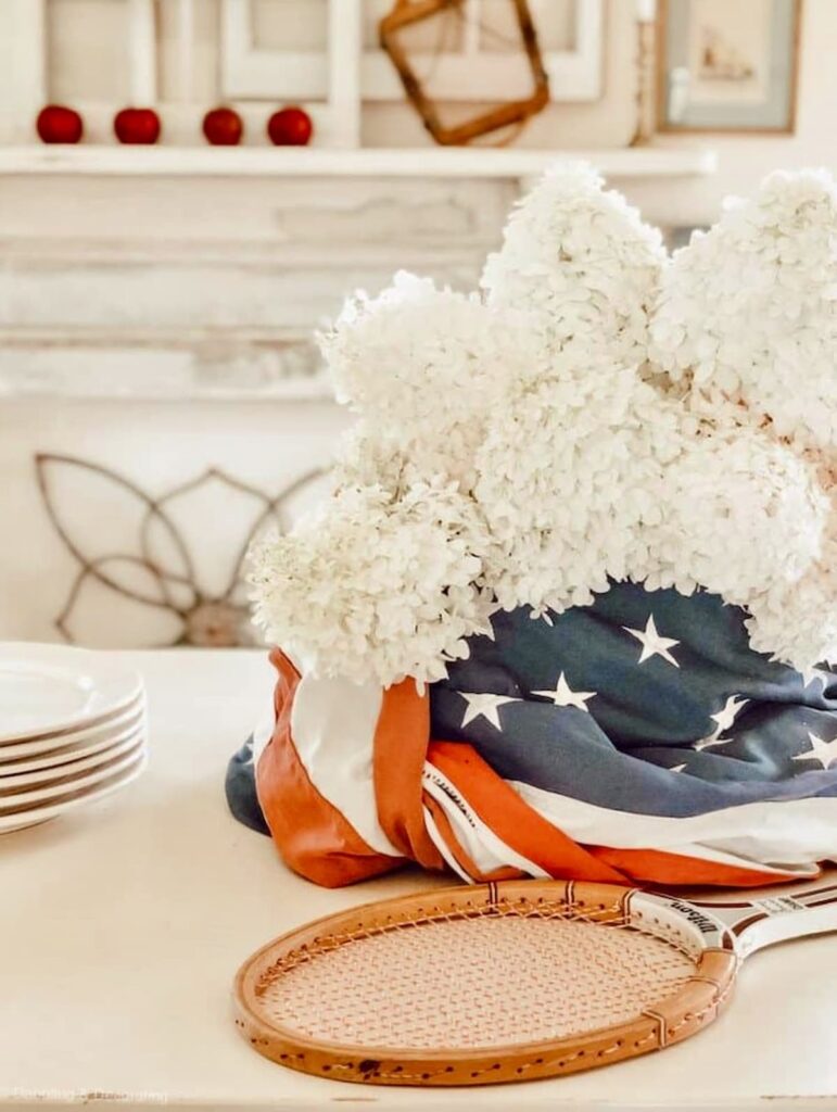 Patriotic Table Centerpiece with American Flag, vintage tennis Rackets and White Hydrangeas