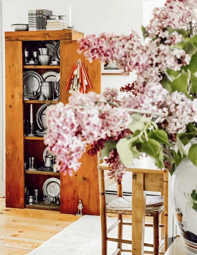 Pewter Collection in Antique Hutch with Lilacs