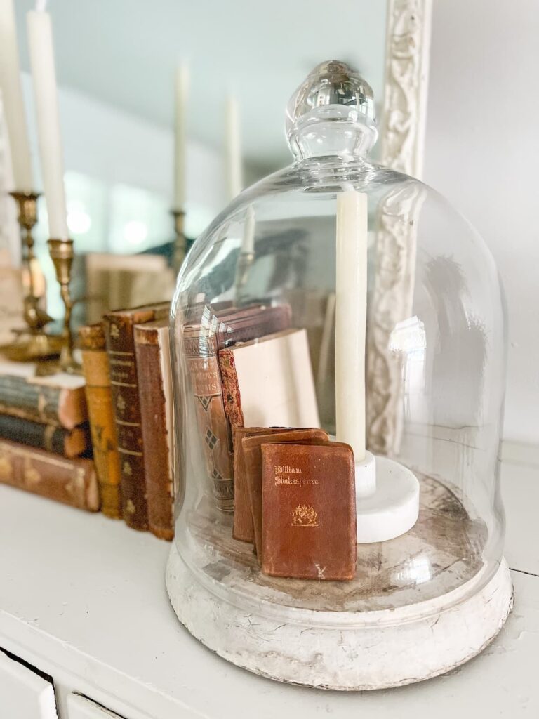 Glass cloche with vintage farmhouse decor.