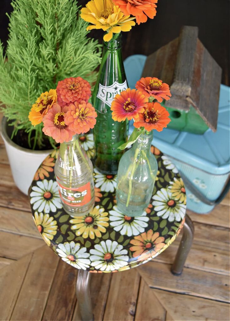 Orange flowers in vintage bottles.