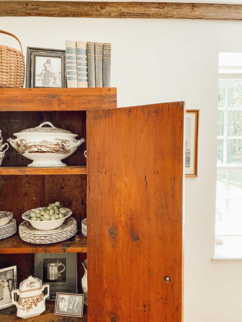 A vintage hutch is filled with transferware