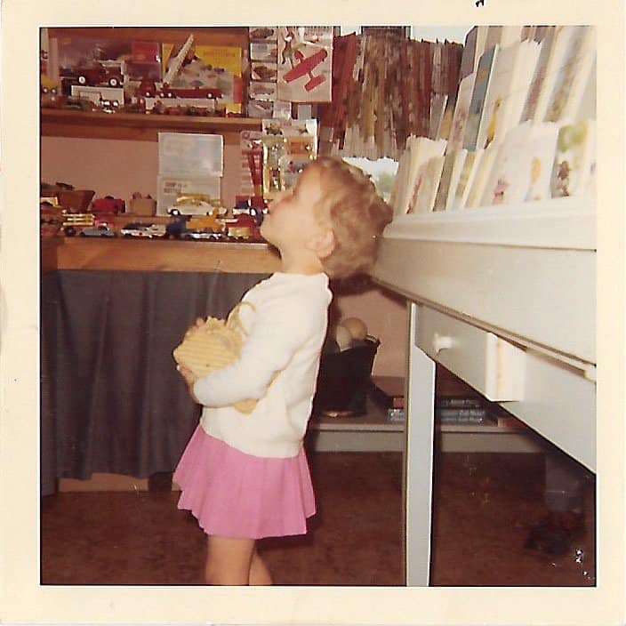 Me shopping as a little girl in the toy section of Coupe's Gift shop with pink skirt and clutched purse.