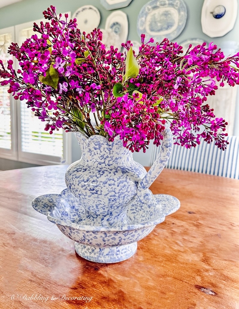 Purple Lilac in Spongeware vase on table.