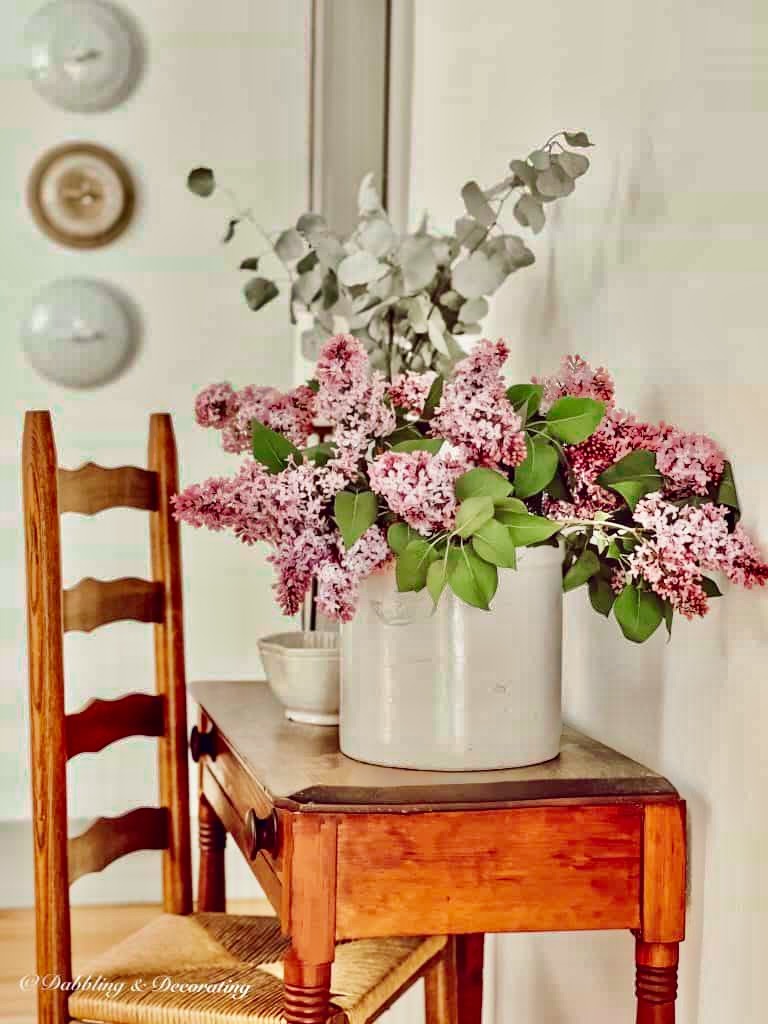 Lilacs in Crock with Antique Table.