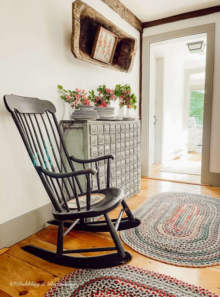 A black Boston Rocker strategically placed in front of a door, adding an elegant touch to the overall decor.