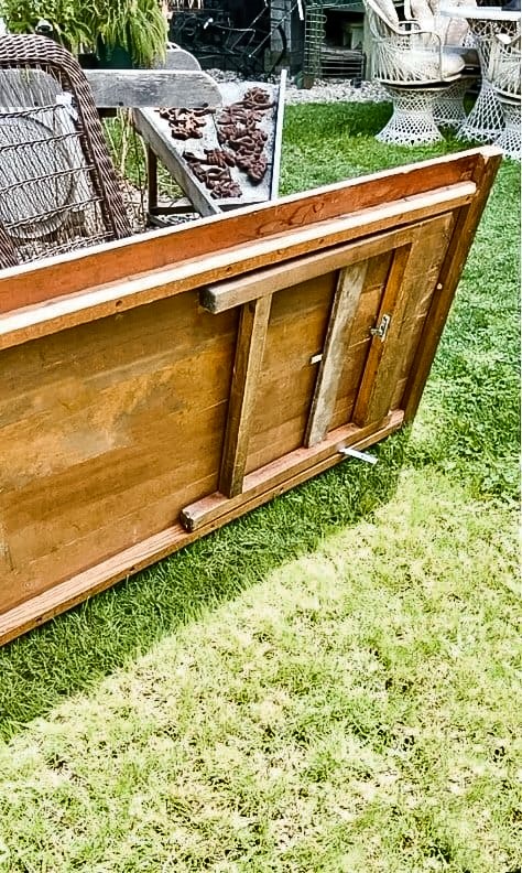 Folding wooden table in the grass at flea market.