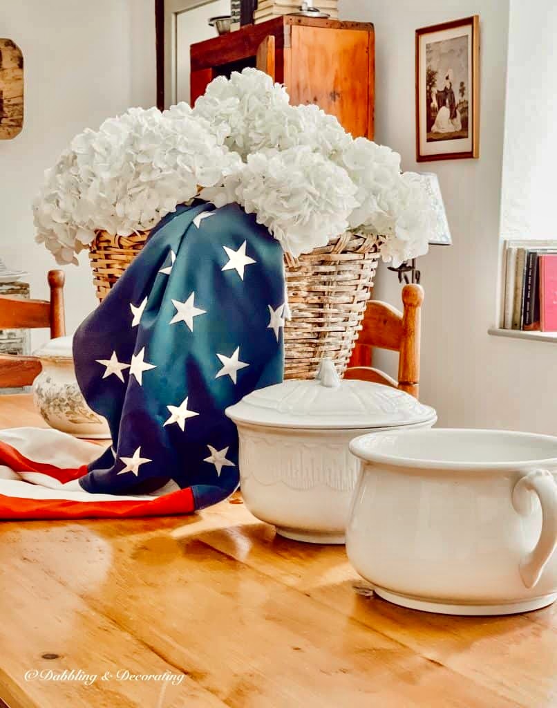 Patriotic Centerpiece on table with white hydrangeas and chamber pots.
