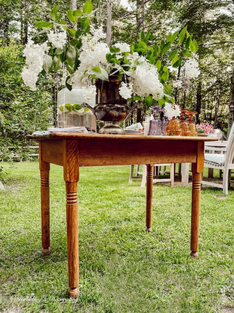 Outdoor small vintage style dining table with flower bouquet.