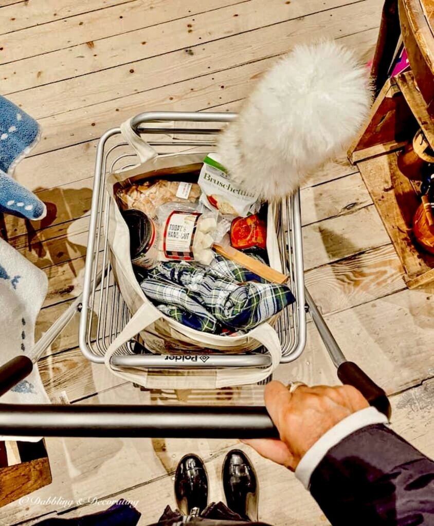 Small shopping cart filled with old fashioned items to check out of store.