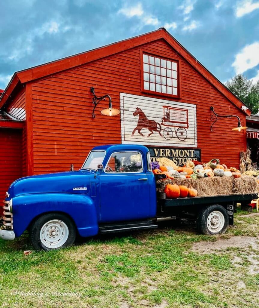 The Vermont Country Store with Vintage Blue Trunk with Hay Bails and Pumpkins.