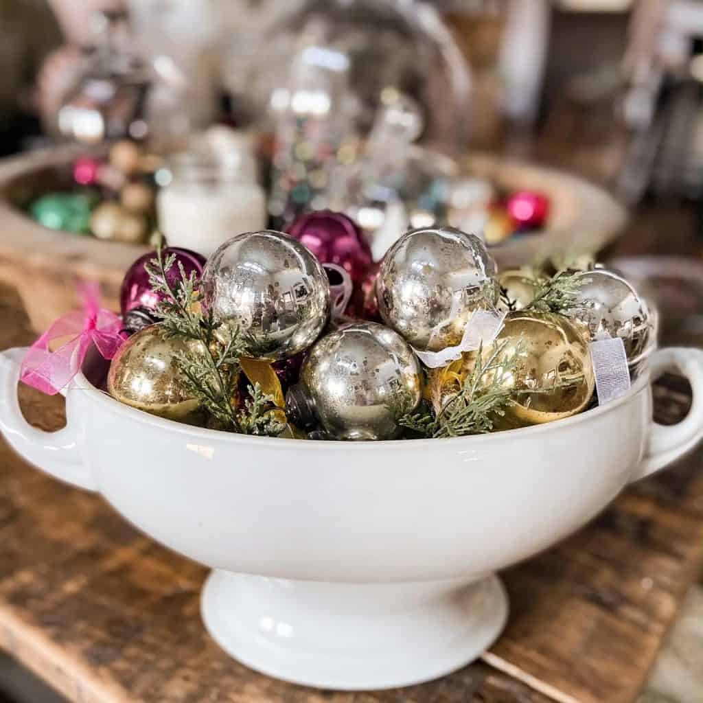 Vintage Christmas ornaments in a white bowl.