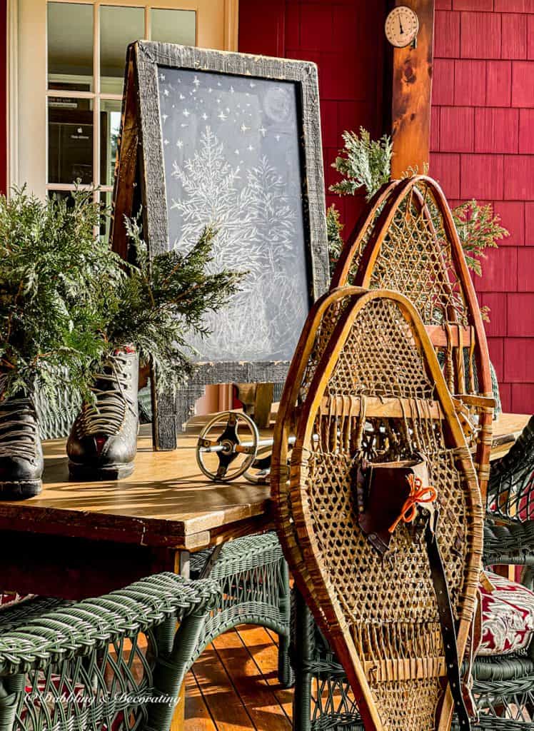 Two pair of snowshoes in vintage ski house decor on winter porch.