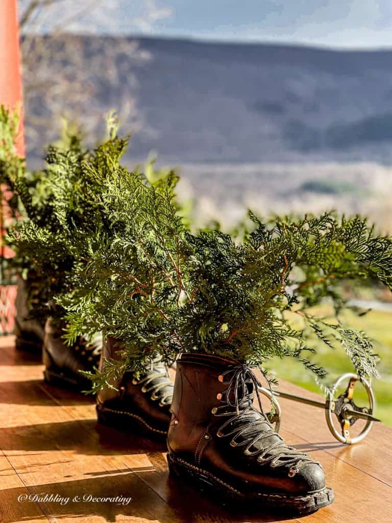 Old ski house decor with evergreens on wooden ski chalet porch in the mountains.