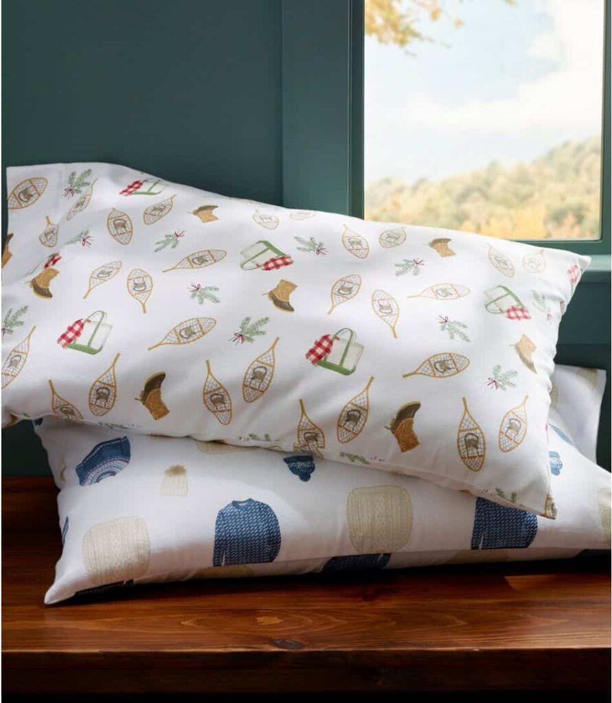 Sara Fitz winter flannel sheet sets with LL Bean boots, bags, and snowshoes.  Cozy Bedding collection.