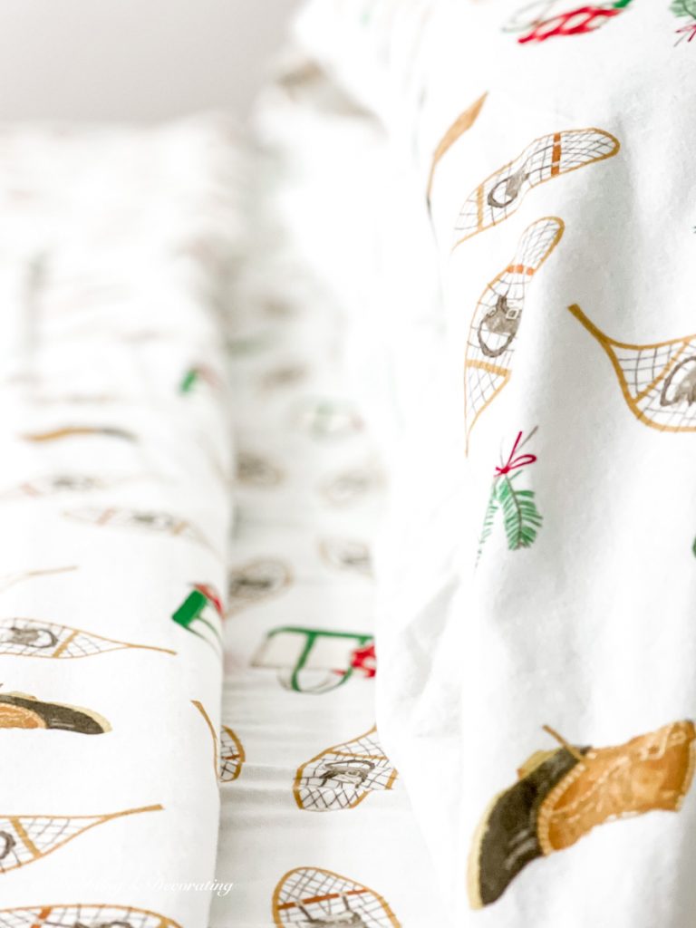 Cozy bedding with winter pattern on flannel sheets close up photo.