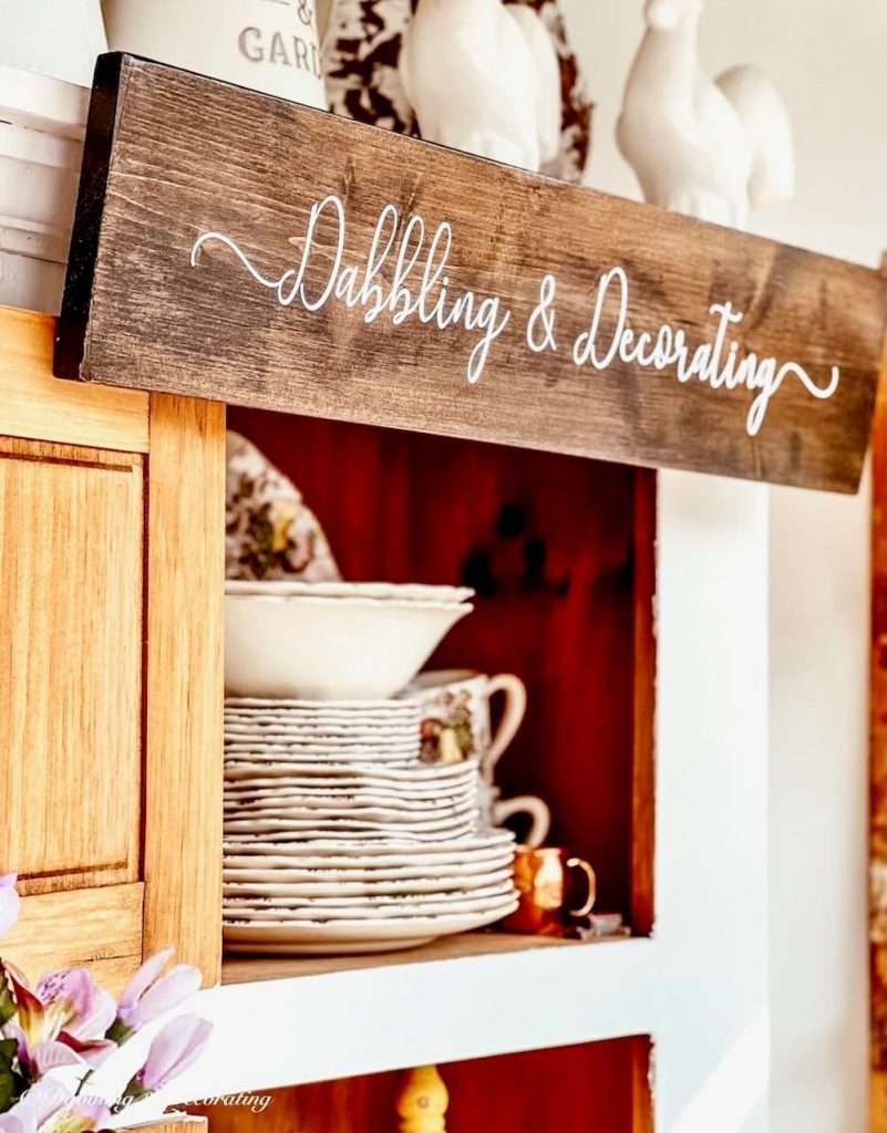 Wooden Sign with Dabbling & Decorating embossed in vintage booth.