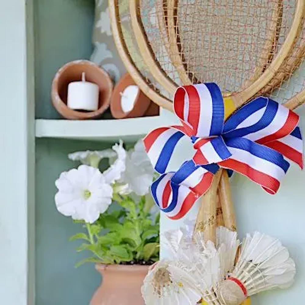 A vintage tennis racket hangs on a wall, adding a unique touch to the home decor.