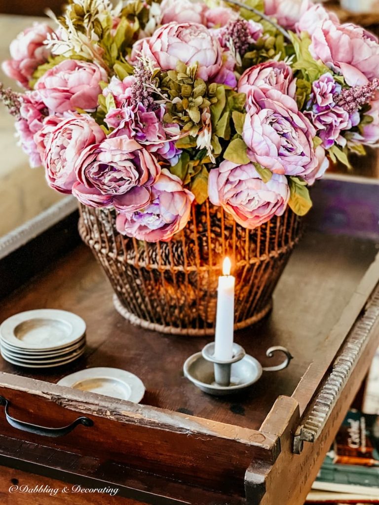 Pink Peonies in metal antique basket on coffee table paired with pewter accents.