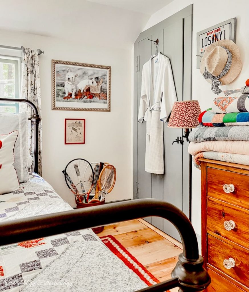 A vintage bedroom with a bed and tennis rackets serving as unique decor.