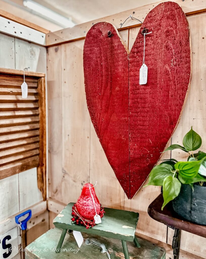 Large Red vintage valentines day heart on wall in antique store.