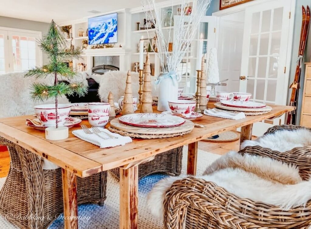 Nordic Table set with winter wonderland Toile dinnerware for Christmas in dining room.