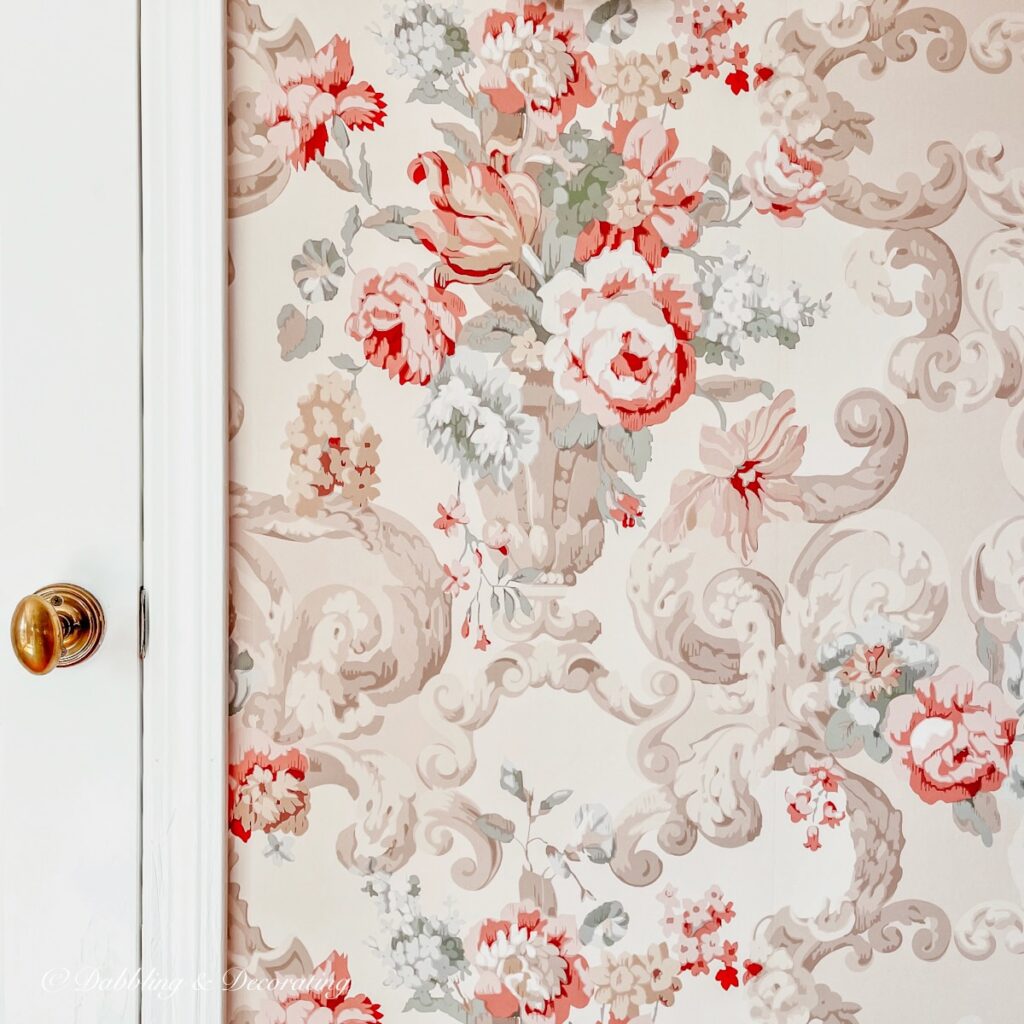 Floral Rococo Red bedroom wallpaper next to white Chantilly Lace door in master bedroom.