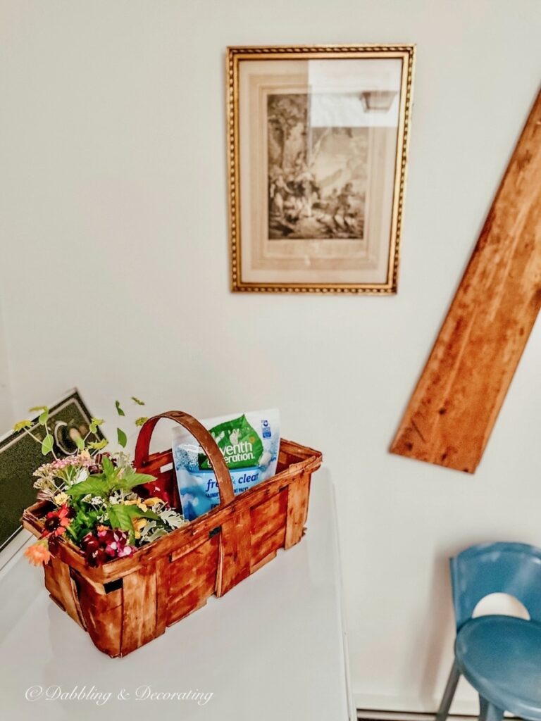 Vintage garden basket of flowers in Laundry room.