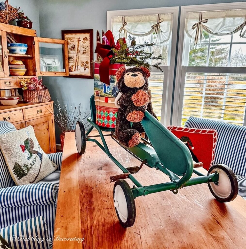Christmas bear on go kart on table with packages