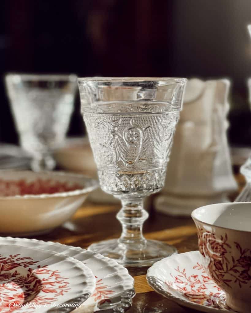 Close up of antique clear goblet on romantic table setting.