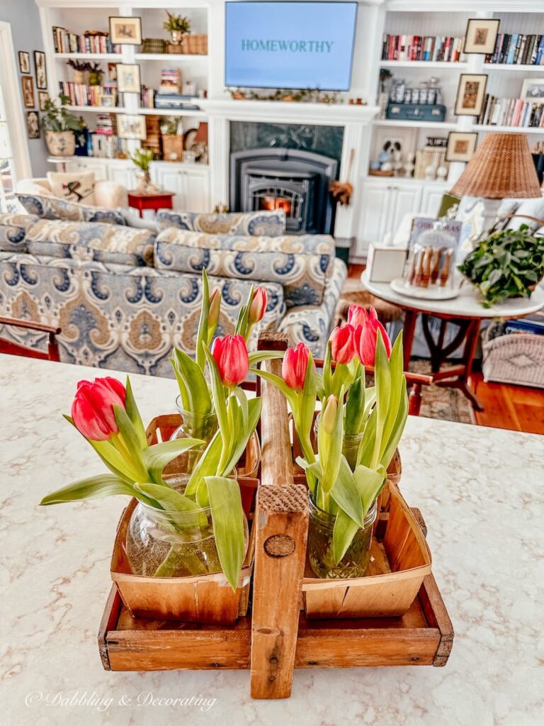 Orange tulips in vintage strawberry picking basket on kitchen counter in home decor.