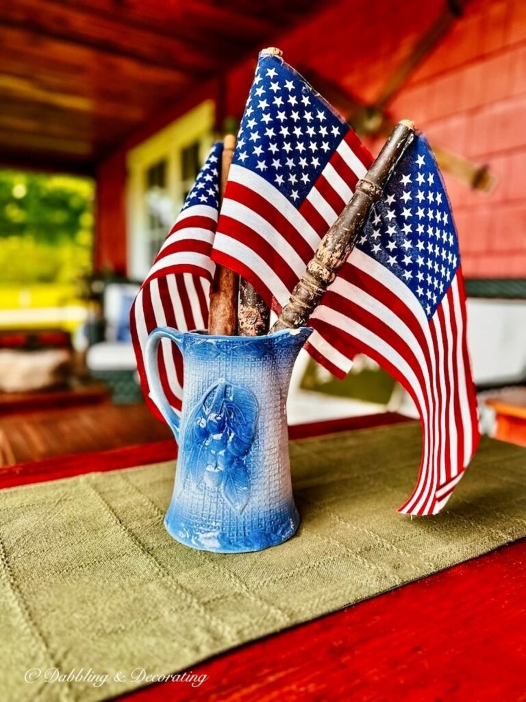 DIY American Flag with Antique Spindles in A.E. Hull Antique Blue Pitcher on Porch