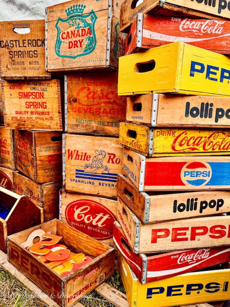 Stacks of vintage crates in red, white, blues, and yellows.