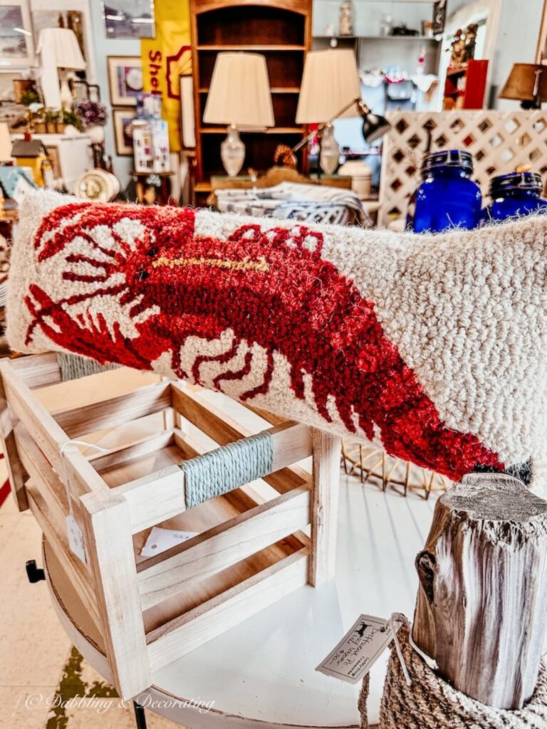 Red lobster pillow in thrift shop.