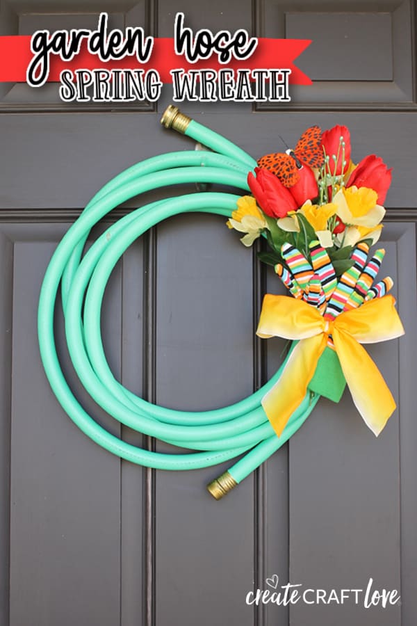 Green Garden Hose Wreath on black door.