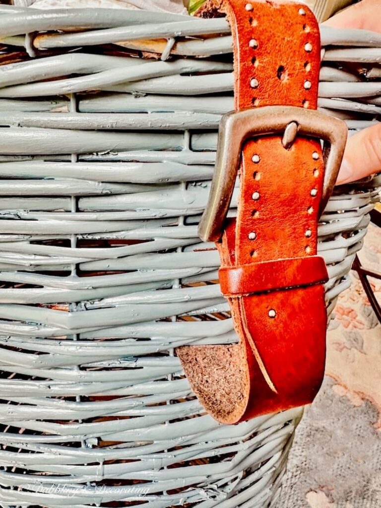 Leather belt woven into blue basket.