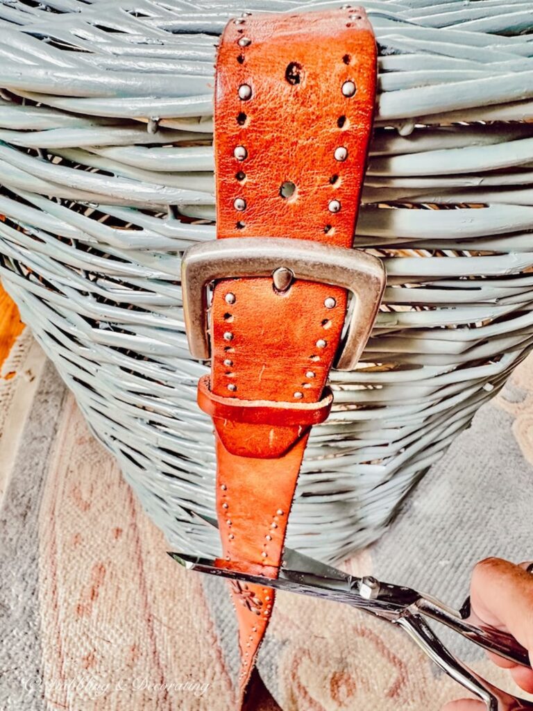 Cutting Leather belt attached to blue basket DIY.