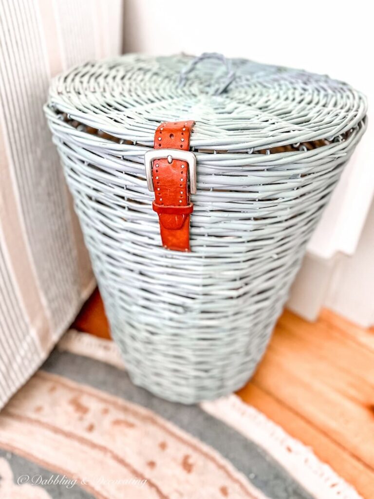 Blue Basket with Belt on front in sunroom.