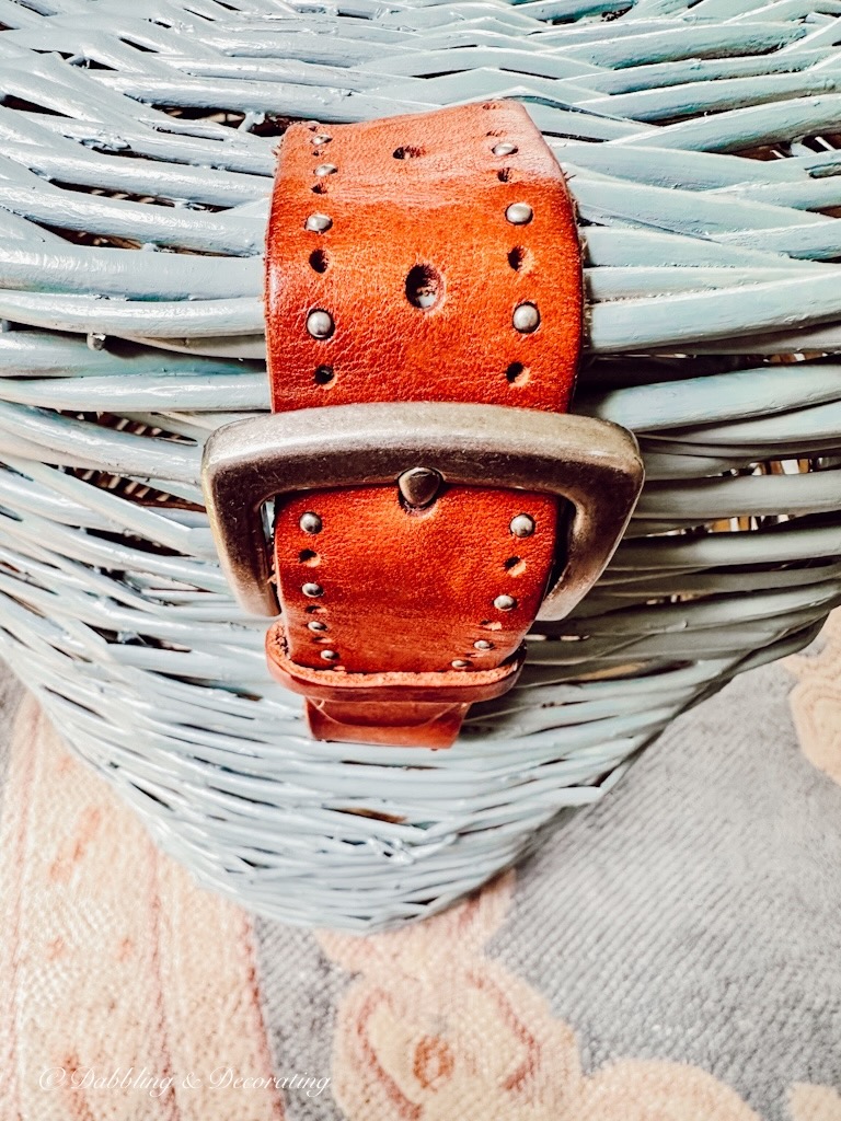 Leather belt attached to blue basket DIY.