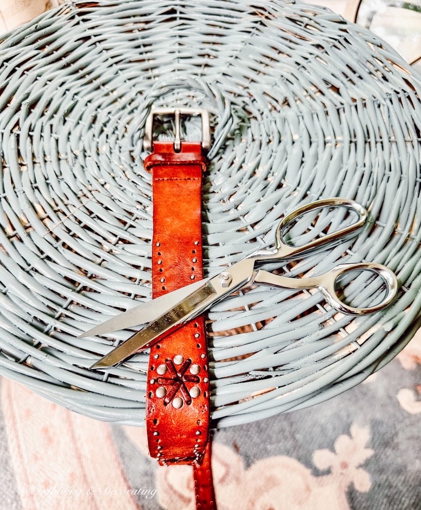 Leather belt, scissors and blue basket.