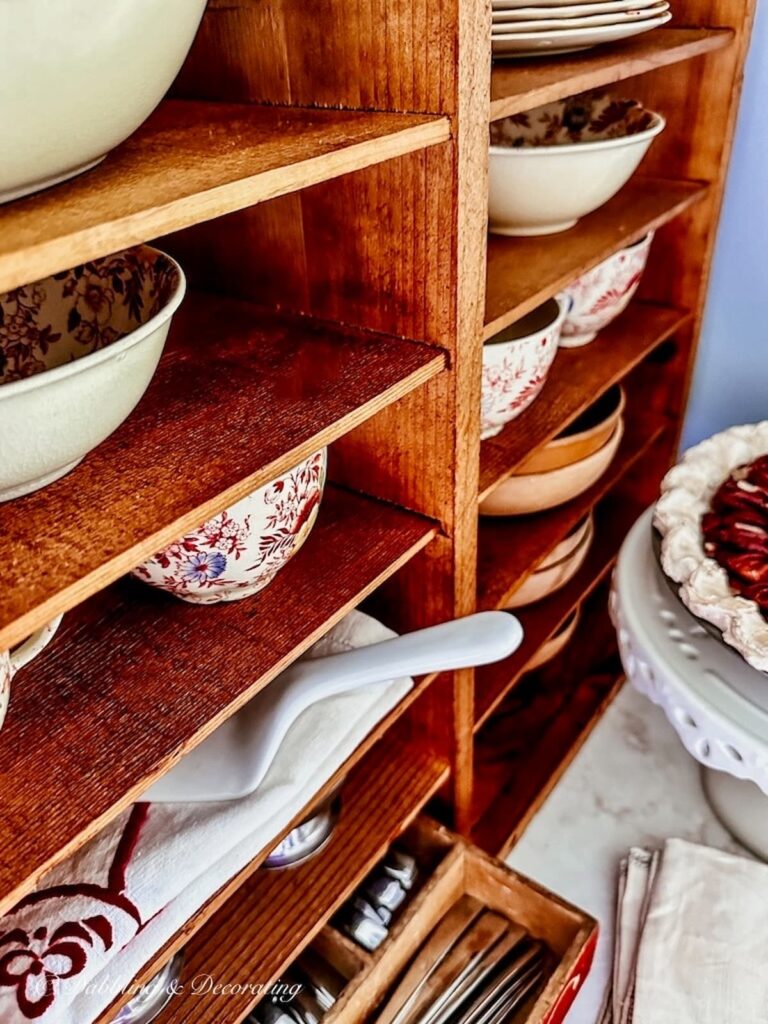 Wooden Shelving with vintage dishware in kitchen.