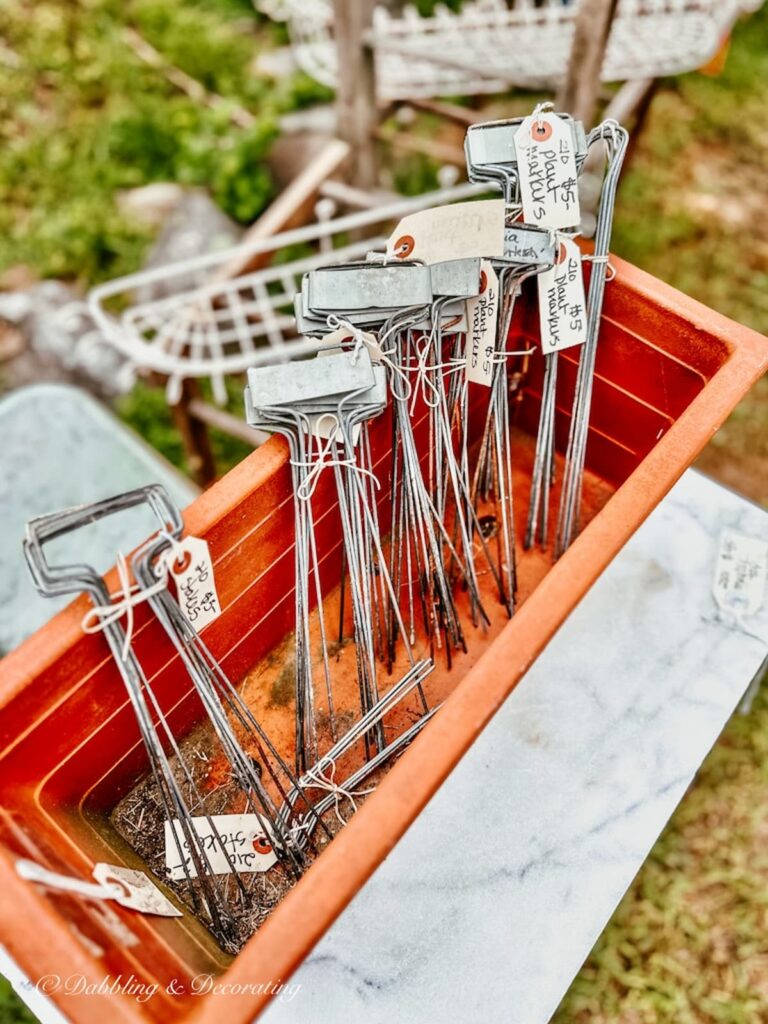 Herb name stakes for planters and gardens in terracotta pot.