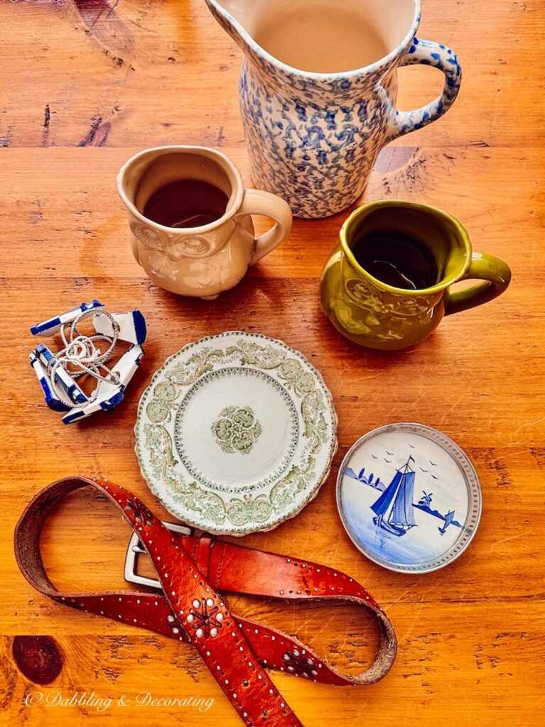 Small vintage haul on table with leather belt.