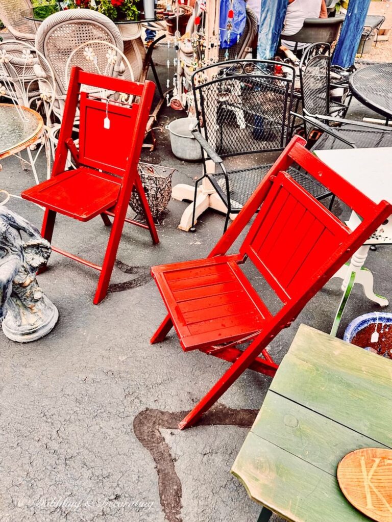 Two red wooden vintage chairs at Sage Farm Antiques.