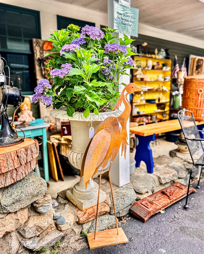 Purple hydrangeas in large antique pot with rustic garden stake at Sage Farm Antiques.